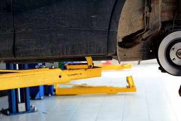 the yellow lift hand at the  lifting safety mark under the car