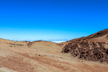 Fototapeta na wymiar Desert like Landscape above the clouds on the slopes of the Teide Mountain, Tenerife, Canary Islands, Spain