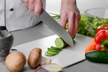Man cutting a cucumber