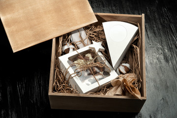 Milk chocolate with filling and cakes in a gift box tied with twine.