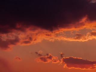 Dramatic sunset sky with orange clouds.