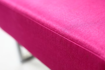 close up detail of pink color fabric covering sofa furniture