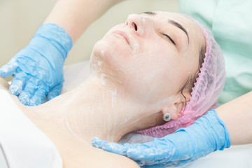 Fototapeta na wymiar Process cosmetic mask of massage and facials in beauty salon 