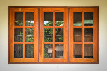 old glass window with wooden frame on wall