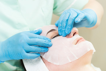 Fototapeta premium Process cosmetic mask of massage and facials in beauty salon 