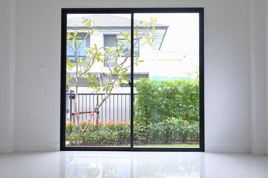 slide glass door with small garden landscaping in front of a new house