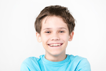 Portrait of an emotional boy on a white background.