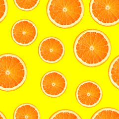 Slices of orange or tangerine isolated on yellow background. Flat lay, top view. Summer fruit composition. seamless pattern