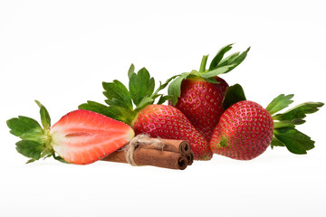 Tasty composition of ripe red strawberry berries with green petals and cinnamon sticks on a neutral white background