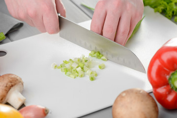 Man chopping spring onions