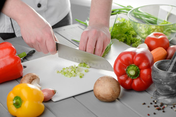 Chef cook chopping spring onions