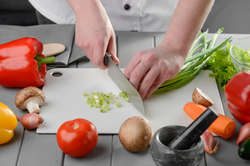 Cook dicing spring onions