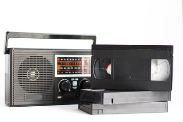 Obraz premium Retro radio with video cassettes on white background