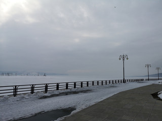 Embankment in the snowy Russian landscape in early spring