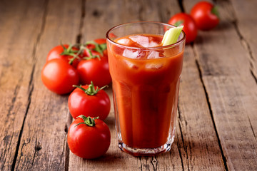 Fresh Tasty Tomato Celery Juice in Glass Fresh Tomatoes and Green Celery on Old Wooden Background Healthy Detox Drink Horizontal