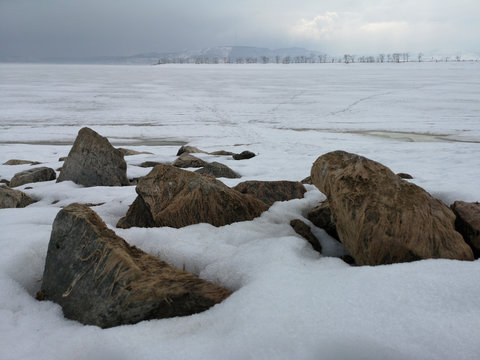 Large stones on the background of the Russian Arctic landscape in early spring