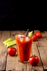 Fresh Tasty Tomato Celery Juice in Glass Fresh Tomatoes and Green Celery on Old Wooden Background Healthy Detox Drink Vertical