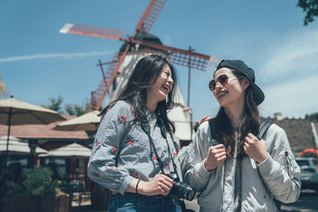 two beautiful asian friends smiling happy travel in copenhagen town denmark. young girls looking...