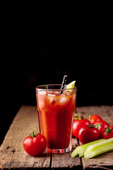 Fresh Tasty Tomato Celery Juice in Glass Fresh Tomatoes and Green Celery on Old Wooden Background Healthy Detox Drink Dark Photo Vertical