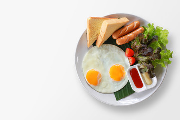Breakfast on plate, fried eggs with vegetables on top.