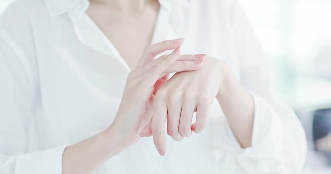 woman applying suncreen lotion