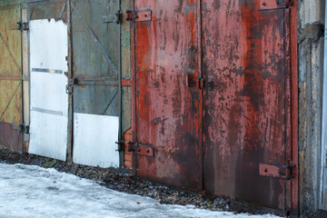 Red old rusty metal gate.