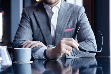 Take a break and have coffee. Business man drinking coffee in a cafe.