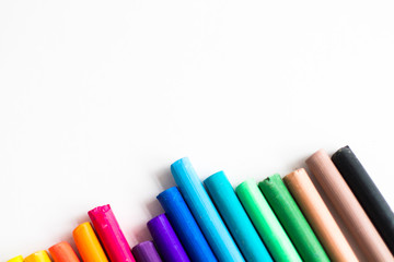 Multi-colored chalk on a white background