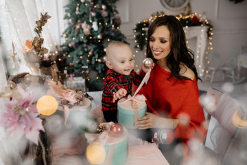 Smiling mom and son unpack New Year's Gift