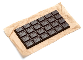 dark chocolate bar on craft packaging paper isolated on white background with clipping path