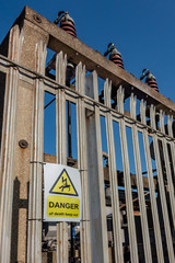 Danger of death keep out warning sign on a palisade fence