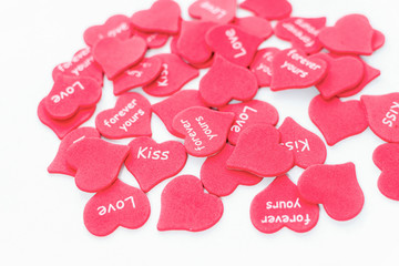 Scattered red hearts as symbol of love on white background white close-up