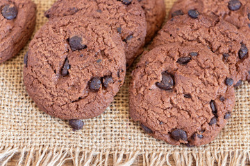 Chocolate chip cookies on sackcloth on the table. Copy space for your text or image.