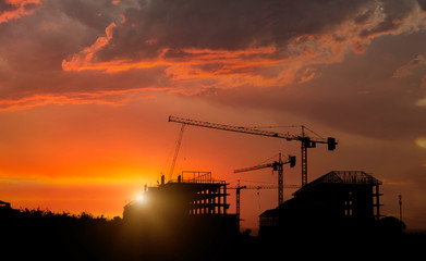 Silhouette Construction Site and Abandon building with sunset background.