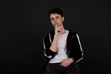 handsome young man posing on black background