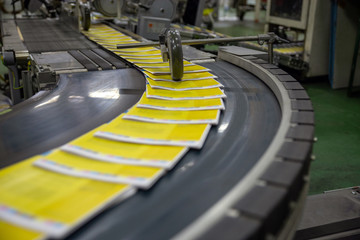 Newspaper production and printing process. The conveyor with magazines. Printing factory. A stream of journal production.