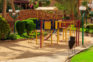 Colorful playground equipment for children in tropical holiday resort