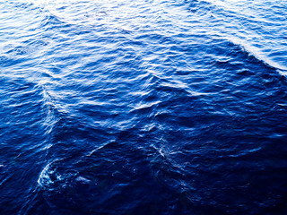 Aerial View of a Crystal clear sea water surface texture. View from above Natural blue background. Turquoise ripple water reflection in tropical beach. Blue ocean wave. Top view. Aerial photography