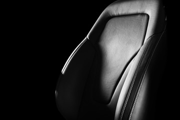Modern luxury car leather interior. Part of leather car seat details with white stitching. Interior...