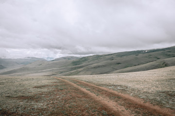 a scene of beautiful and majestic mountainous mountains against the background of a cloudy sky with...