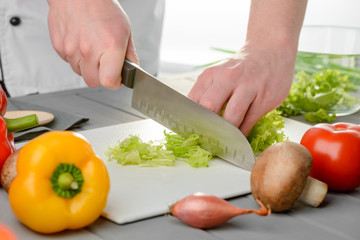 Chef cutting fresh leaves