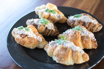 Croissant with Tuna Salad  Sandwich on wood table