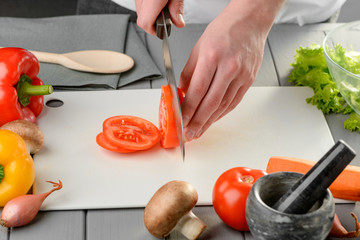 Man slicing a juicy tomato