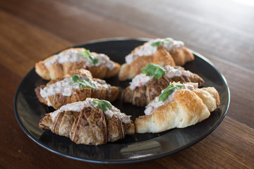 Croissant with Tuna Salad  Sandwich on wood table