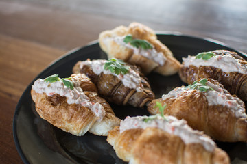 Croissant with Tuna Salad  Sandwich on wood table