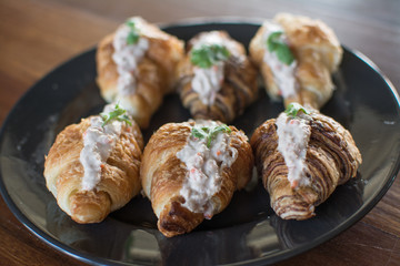 Croissant with Tuna Salad  Sandwich on wood table
