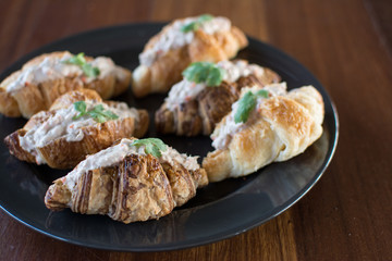 Croissant with Tuna Salad  Sandwich on wood table