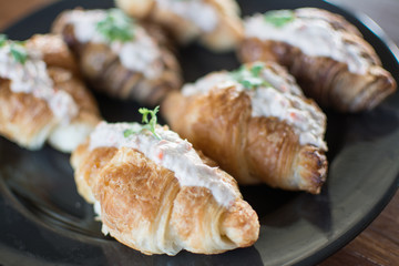 Croissant with Tuna Salad  Sandwich on wood table