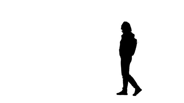 Silhouette of a woman walking in the street. Side view . White background