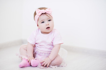 Cute baby girl wearing princess dress and headband close up. Childhood.